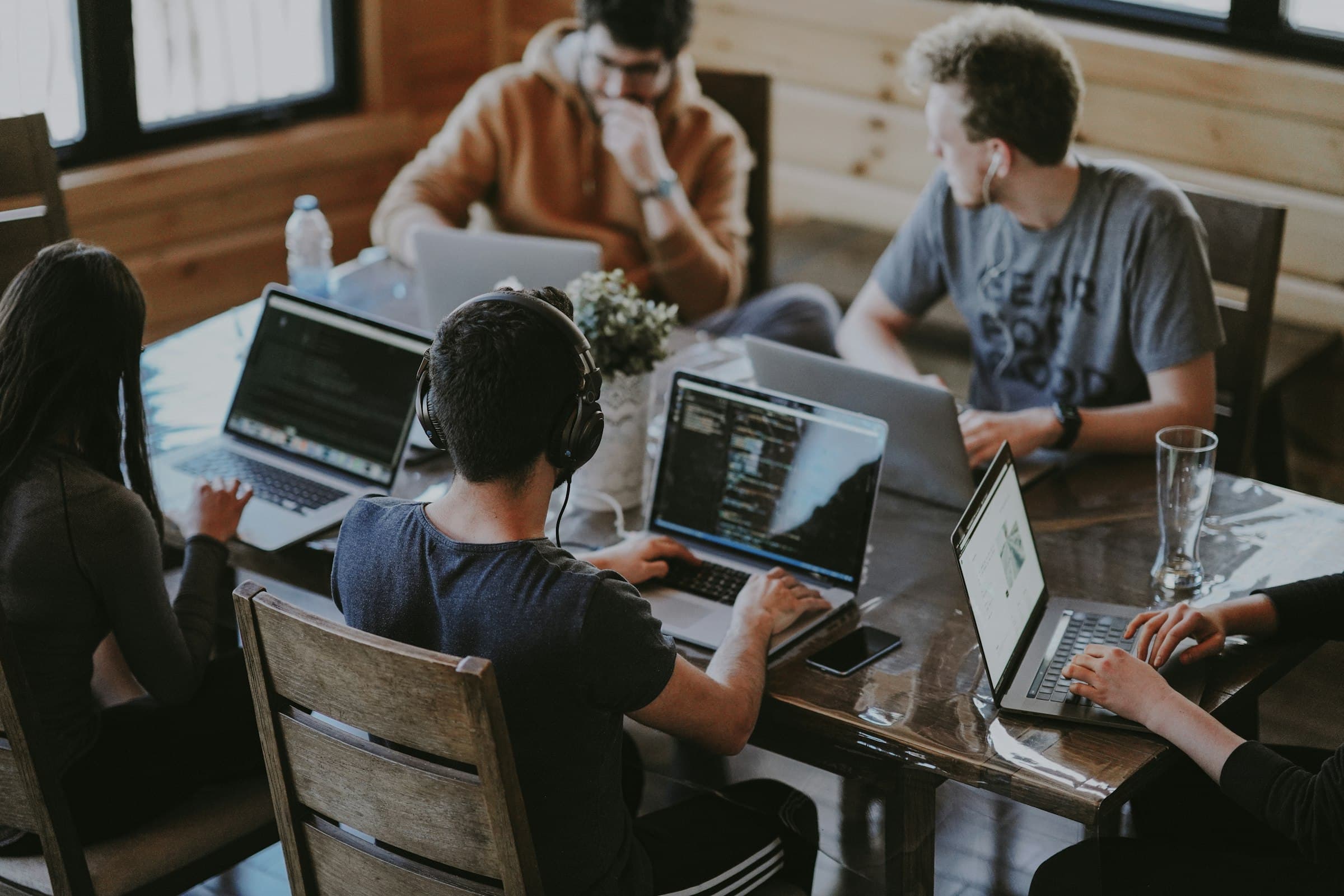 Engineers pairing on code around a shared table